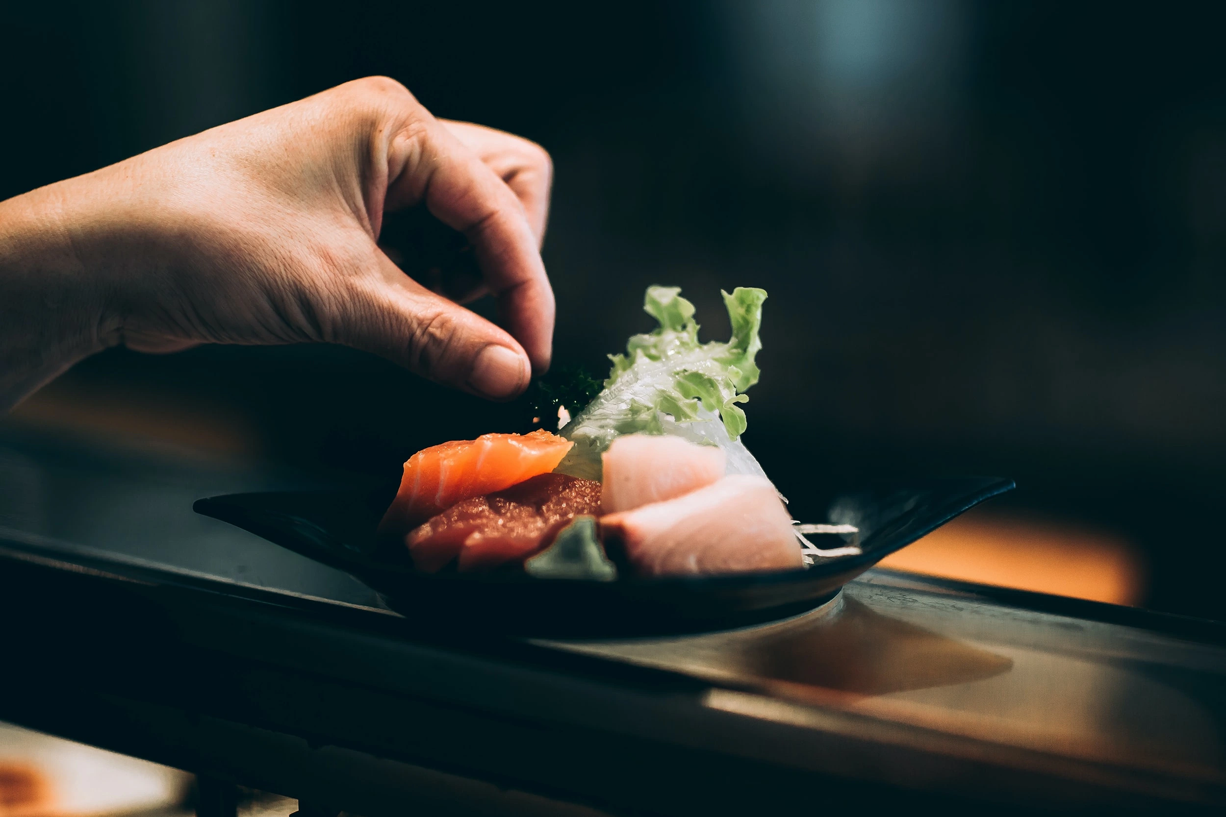 Hand seasoning sashimi dish